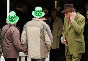 14 March 2012; A couple wearing plastic shamrock hats in attendance during Ladies Day at the Cheltenham Festival. Cheltenham Racing Festival, Prestbury Park, Cheltenham, England. Picture credit: Brendan Moran / SPORTSFILE - read more