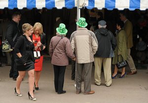 14 March 2012; A couple wearing plastic shamrock hats in attendance during Ladies Day at the Cheltenham Festival. Cheltenham Racing Festival, Prestbury Park, Cheltenham, England. Picture credit: Brendan Moran / SPORTSFILE - read more