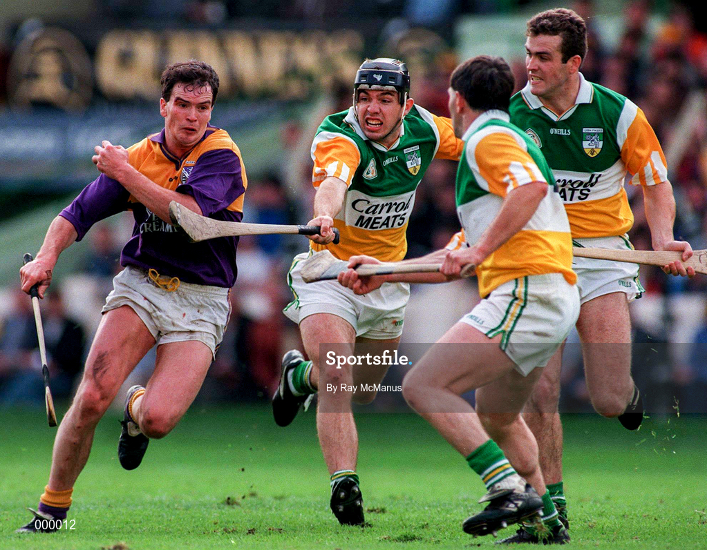 22 June 1997; Adrian Fenlon of Wexford, in action against Colm Cassidy, left, with, Martin Hanamy, and Kevin Martin of Offaly, right during the GAA Leinster Senior Hurling Championship Semi-Final match between Wexford and Offaly at Croke Park in Dublin. Photo by Ray McManus/Sportsfile