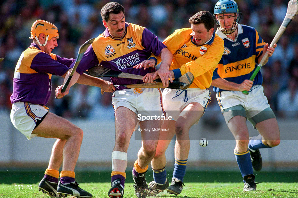 17 August 1997; Billy Byrne of Wexford, second from left, supported by team-mate Larry Murphy, left, in action against Brendan Cummins and Noel Sheehy of Tipperary during the GAA All-Ireland Senior Hurling Championship Semi-Final match between Tipperary and Wexford at Croke Park in Dublin. Photo by Ray McManus/Sportsfile