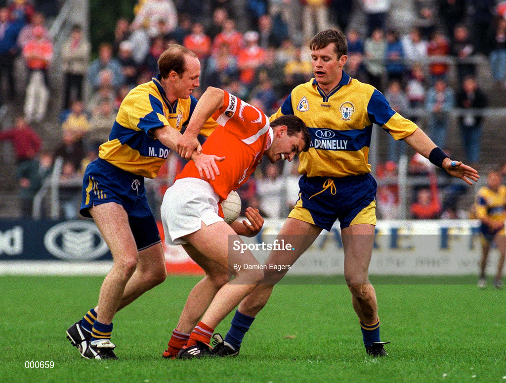 22 June 1997; Fachtna Collins of Cork in action against Donal O'Sullivan, left, with, Michael Hynes of Clare during the GAA Munster Senior Football Championship Semi-Final match between Clare and Cork at Cusack Park in Ennis, Co Clare. Photo by Damien Eagers/Sportsfile