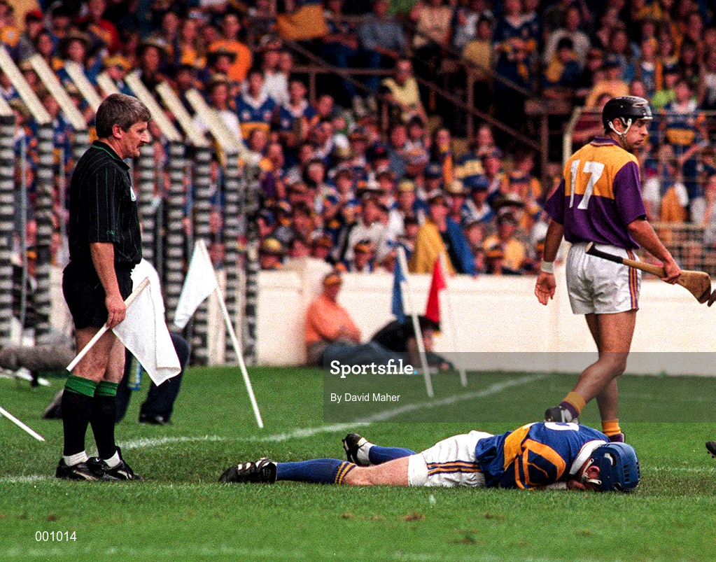 17 August 1997; Linesman Pat Horan lookes on as John Leahy of Tipperary lays on the ground after a clash with John O'Connor of Wexford during the GAA All-Ireland Senior Hurling Championship Semi-Final match between Tipperary and Wexford at Croke Park in Dublin. Photo by David Maher/Sportsfile