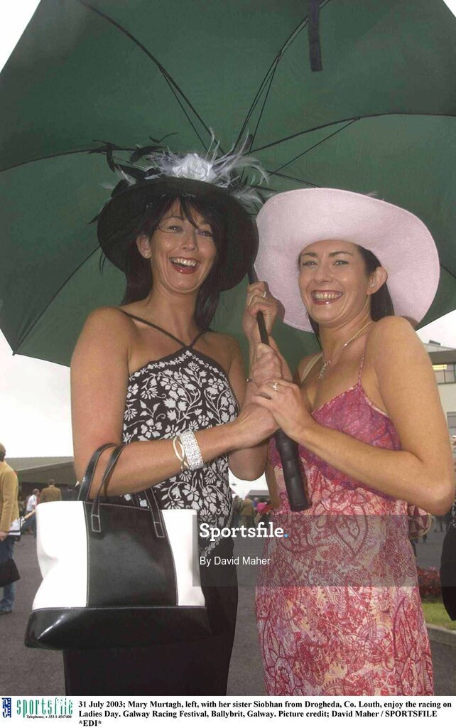 31 July 2003; Mary Murtagh, left, with her sister Siobhan from Drogheda, Co. Louth, enjoy the racing on Ladies Day. Galway Racing Festival, Ballybrit, Galway. Picture credit; David Maher / SPORTSFILE *EDI*