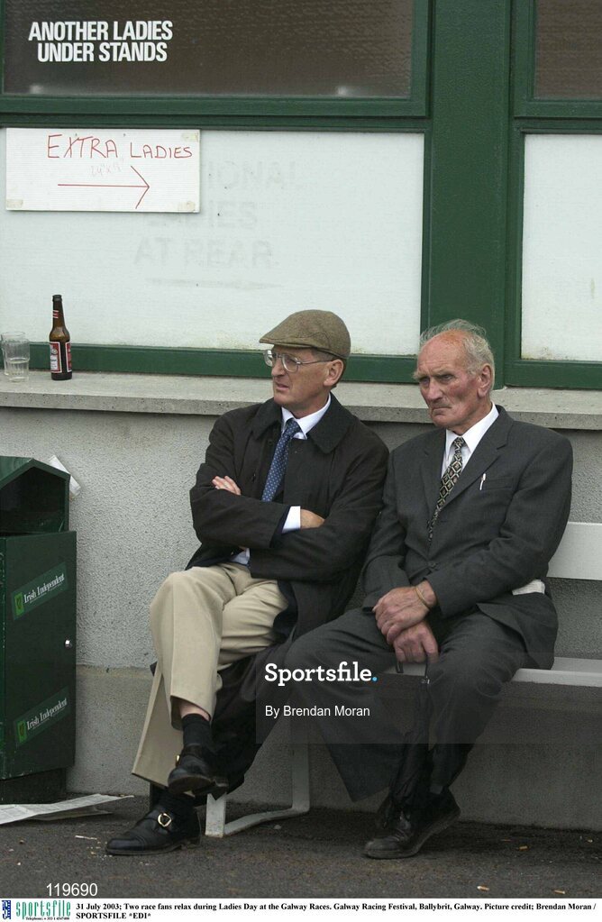 31 July 2003; Two race fans relax during Ladies Day at the Galway Races. Galway Racing Festival, Ballybrit, Galway. Picture credit; Brendan Moran / SPORTSFILE *EDI*
