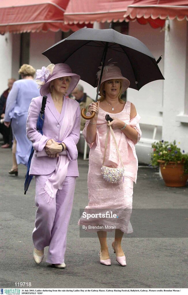 31 July 2003; Ladies sheltering from the rain during Ladies Day at the Galway Races. Galway Racing Festival, Ballybrit, Galway. Picture credit; Brendan Moran / SPORTSFILE *EDI*