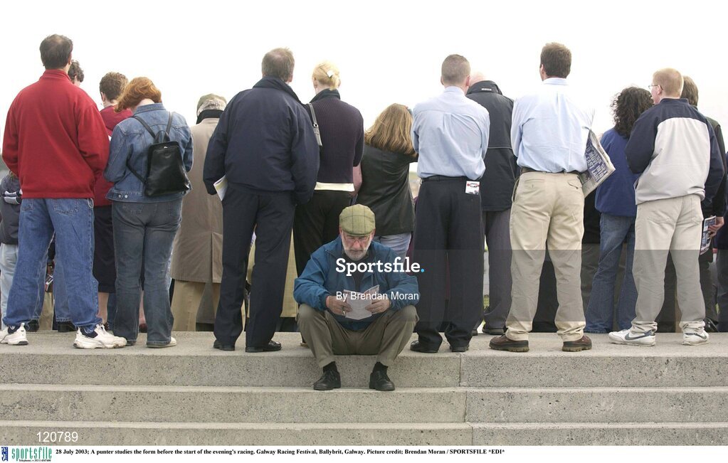 28 July 2003; A punter studies the form before the start of the evening's racing. Galway Racing Festival, Ballybrit, Galway. Picture credit; Brendan Moran / SPORTSFILE *EDI*