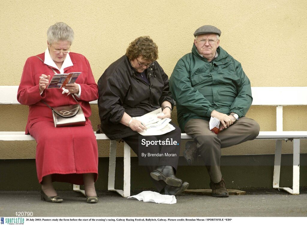 28 July 2003; Punters study the form before the start of the evening's racing. Galway Racing Festival, Ballybrit, Galway. Picture credit; Brendan Moran / SPORTSFILE *EDI*