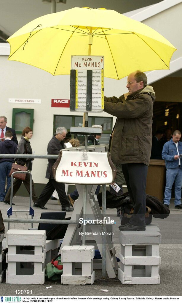 28 July 2003; A bookmaker gets his stall ready before the start of the evening's racing. Galway Racing Festival, Ballybrit, Galway. Picture credit; Brendan Moran / SPORTSFILE *EDI*