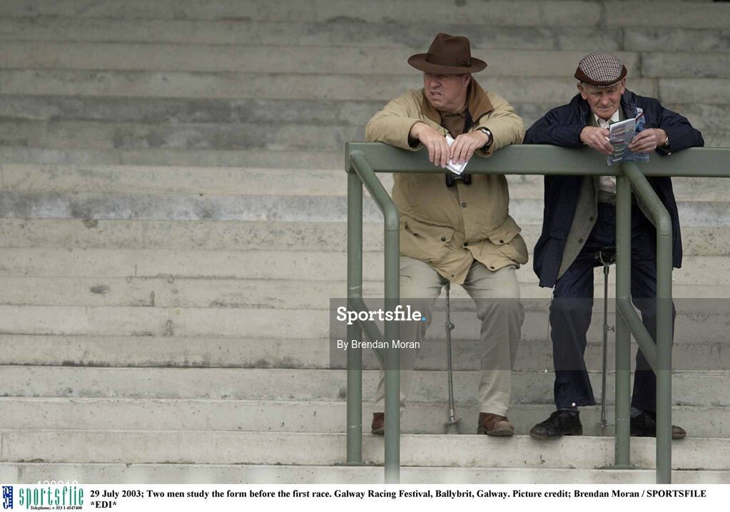 29 July 2003; Two men study the form before the first race. Galway Racing Festival, Ballybrit, Galway. Picture credit; Brendan Moran / SPORTSFILE *EDI*