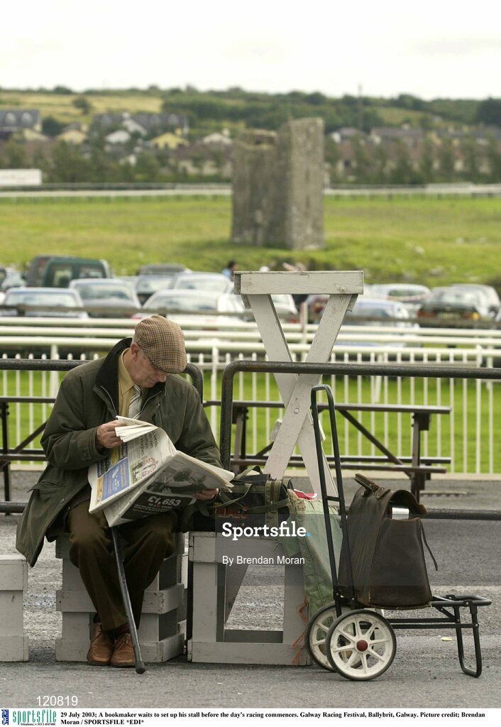 29 July 2003; A bookmaker waits to set up his stall before the day's racing commences. Galway Racing Festival, Ballybrit, Galway. Picture credit; Brendan Moran / SPORTSFILE *EDI*