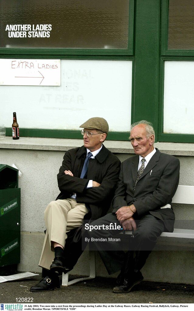31 July 2003; Two men take a rest from the proceedings during Ladies Day at the Galway Races. Galway Racing Festival, Ballybrit, Galway. Picture credit; Brendan Moran / SPORTSFILE *EDI*