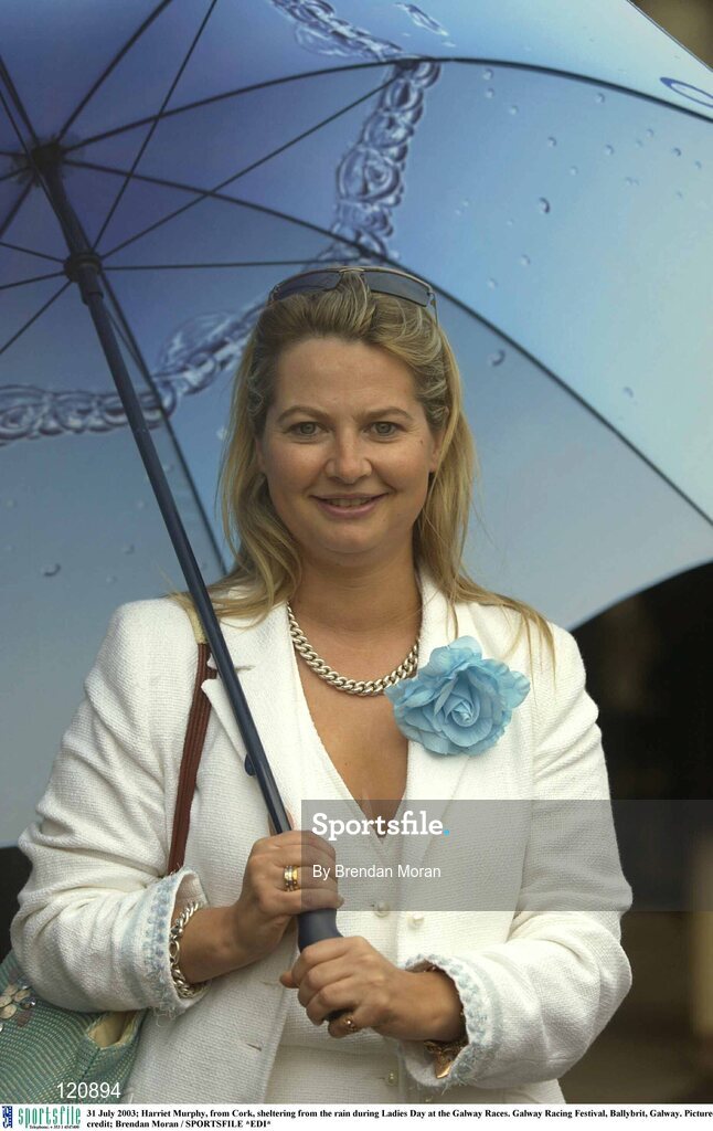 31 July 2003; Harriet Murphy, from Cork, sheltering from the rain during Ladies Day at the Galway Races. Galway Racing Festival, Ballybrit, Galway. Picture credit; Brendan Moran / SPORTSFILE *EDI*