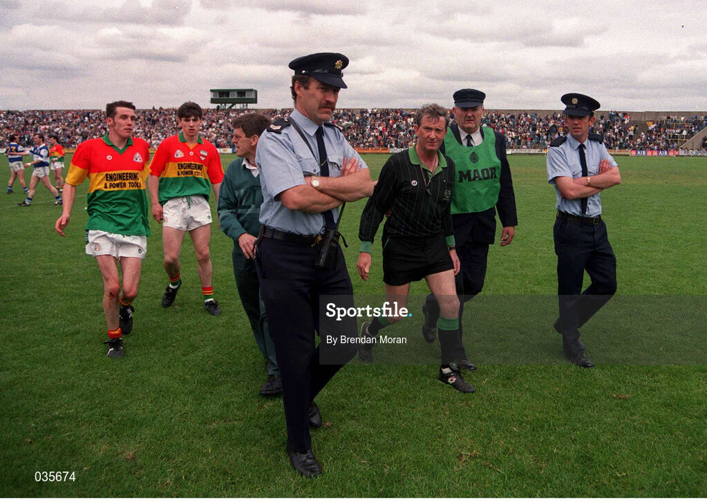 18 June 1995; Referee Noel Cooney is escorted off the field after Carlow were denied an equalising point during the Leinster Football Championship match between Carlow and Laois at O'Moore Park in Laois. Photo by Brendan Moran/Sportsfile