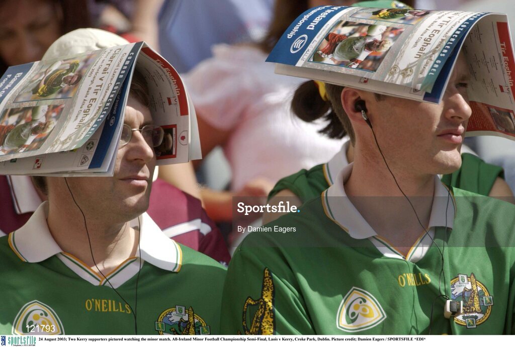 24 August 2003; Two Kerry supporters attempt to block the sun using the matchday programme during the All-Ireland Minor Football Championship Semi-Final between Laois and Kerry at Croke Park, Dublin. Photo by Damien Eagers/Sportsfile