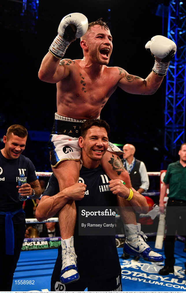18 August 2018; Carl Frampton celebrates his victory against Luke Jackson with coach Nigel Travis following their interim World Boxing Organisation World Featherweight Title bout at Windsor Park in Belfast. Photo by Ramsey Cardy/Sportsfile