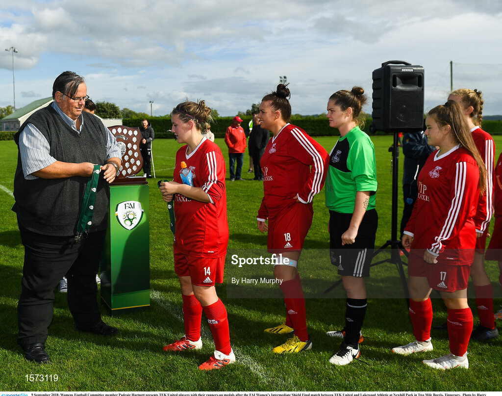 9 September 2018; Womens Football Committee member Padraig Hartnett presents TEK United players with their runners-up medals after the FAI Women’s Intermediate Shield Final match between TEK United and Lakewood Athletic at Newhill Park in Two Mile Borris, Tipperary.  Photo by Harry Murphy/Sportsfile