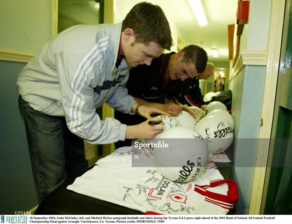 10 September 2003; Enda McGinley, left, and Michael McGee autograph footballs and shirts during the Tyrone GAA press night ahead of the 2003 Bank of Ireland All-Ireland Football Championship Final against Armagh. Carrickmore, Co. Tyrone. Picture credit; SPORTSFILE *EDI*