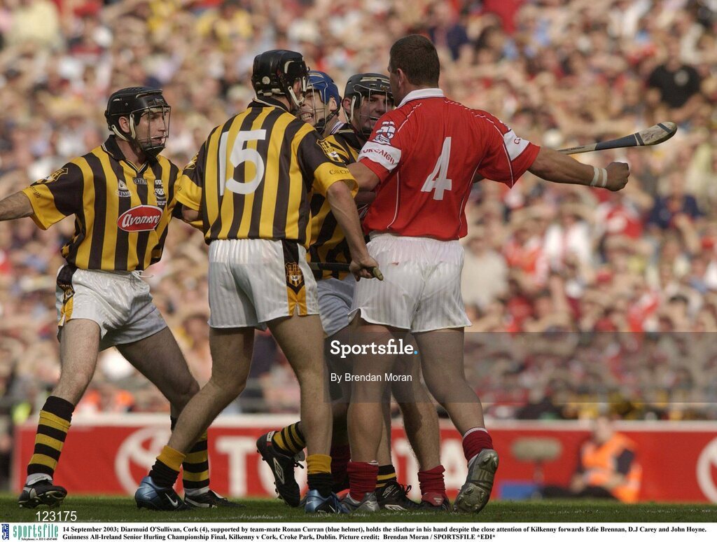 14 September 2003; Diarmuid O'Sullivan, Cork (4), supported by team-mate Ronan Curran (blue helmet), holds the sliothar in his hand despite the close attention of Kilkenny forwards Eddie Brennan, DJ Carey and John Hoyne. Guinness All-Ireland Senior Hurling Championship Final, Kilkenny v Cork, Croke Park, Dublin. Picture credit;  Brendan Moran / SPORTSFILE *EDI*