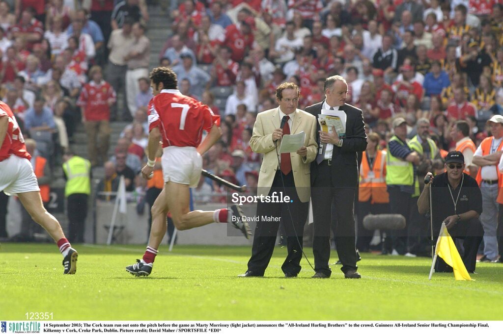 14 September 2003; The Cork team run out onto the pitch before the game as Marty Morrissey (light jacket) announces the "All-Ireland Hurling Brothers" to the crowd. Guinness All-Ireland Senior Hurling Championship Final, Kilkenny v Cork, Croke Park, Dublin. Picture credit; David Maher / SPORTSFILE *EDI*