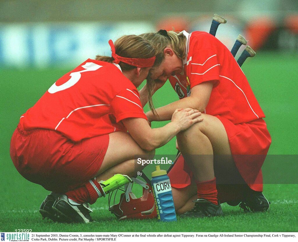 21 September 2003; Denise Cronin, 3, consoles team-mate Mary O'Connor at the final whistle after defeat against Tipperary. Foras na Gaeilge All-Ireland Senior Championship Final, Cork v Tipperary, Croke Park, Dublin. Picture credit; Pat Murphy / SPORTSFILE