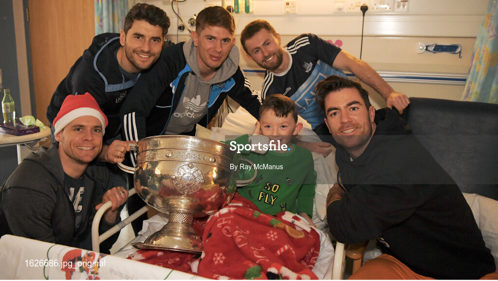 25 December 2018; Captain Stephen Cluxton, Bernard Brogan, Michael Fitzsimons, Jack McCaffrey and Michael Darragh Macauley, with eight year old Ross Duffy, from Coolock, Dublin, and the Sam Maguire Cup during the Dublin Football team visit to the Children's University Hospital, Temple Street in Dublin. Photo by Ray McManus/Sportsfile