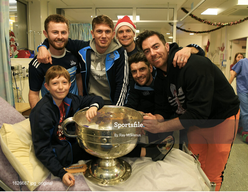 25 December 2018; Jack McCaffrey, Michael Fitzsimons, captain Stephen Cluxton, Bernard Brogan, Michael Darragh Macauley with Séamus Byrne, eleven years old, from Cabra, Dublin, and the Sam Maguire Cup during the Dublin Football team visit to the  Children's University Hospital, Temple Street in Dublin. Photo by Ray McManus/Sportsfile