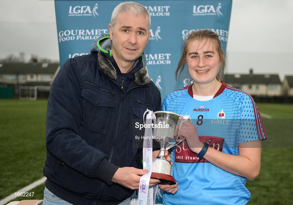 8 March 2019; Amy Wharton of NUIG is presented the trophy by Chairperson of HEC Donal Barry followingthe Gourmet Food Parlour Donaghy Cup Final match between Galway Mayo Institute of Technology and Marino at TU Dublin Broombridge Sports Grounds in Dublin. Photo by Harry Murphy/Sportsfile