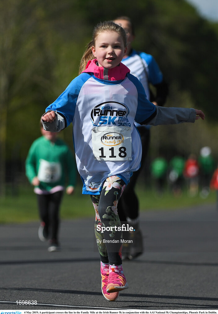 4 May 2019; A participant crosses the line in the Family Mile at the Irish Runner 5k in conjunction with the AAI National 5k Championships, Phoenix Park in Dublin. Photo by Brendan Moran/Sportsfile