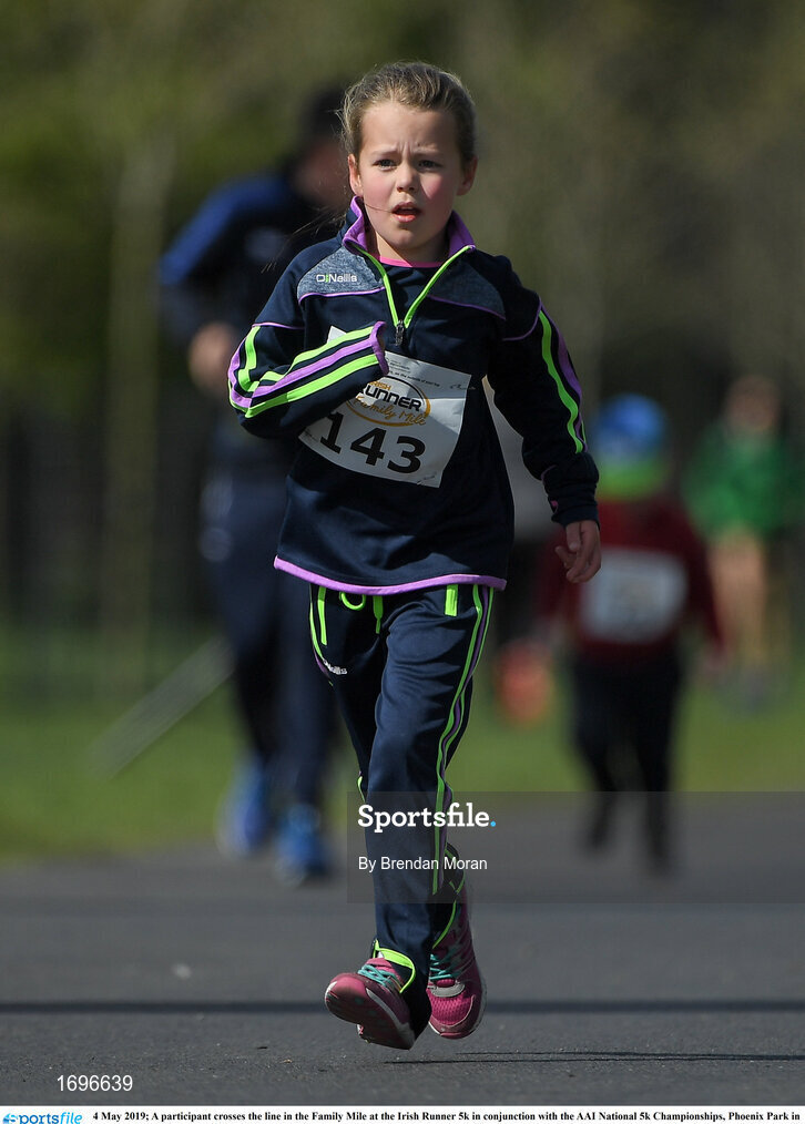 4 May 2019; A participant crosses the line in the Family Mile at the Irish Runner 5k in conjunction with the AAI National 5k Championships, Phoenix Park in Dublin. Photo by Brendan Moran/Sportsfile