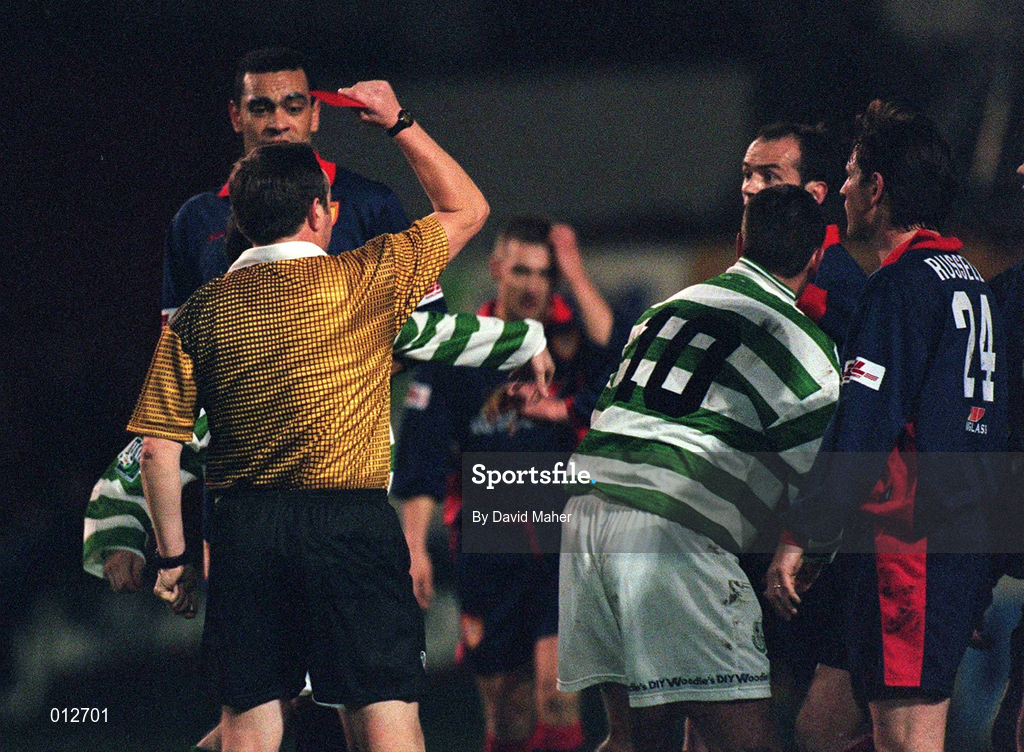 30 October 1998; Referee John mcDermott shows a red card to Packie Lynch of St Patrick's Athletic after a challenge on Mark O'Neill of Shamrock Rovers during the Harp Lager National League Premier Division match between Shamrock Rovers and St Patrick's Athletic at Tolka Park in Dublin. Photo by David Maher/Sportsfile