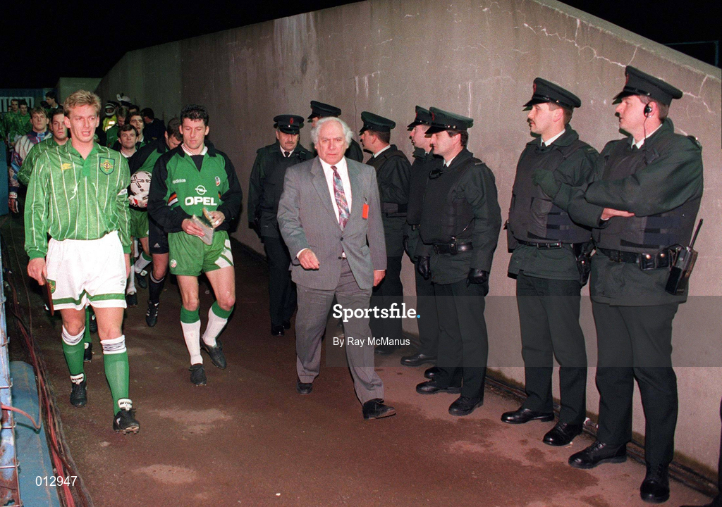 17 November 1993; Northern Ireland captain Alan McDonald and Republic of Ireland captain Andy Townsend lead their teams onto the field, watched by the RUC, during the FIFA World Cup Qualifier match between Northern Ireland and Republic of Ireland at Windsor Park in Belfast. Photo by Ray McManus/Sportsfile