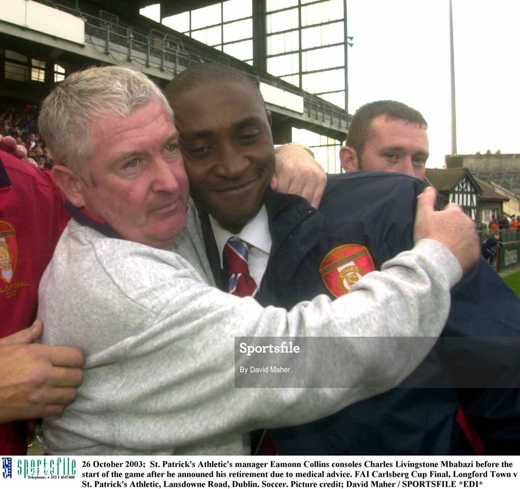 26 October 2003;  St. Patrick's Athletic's manager Eamonn Collins consoles Charles Livingstone Mbabazi before the start of the game after he announed his retirement due to medical advice. FAI Carlsberg Cup Final, Longford Town v St. Patrick's Athletic, Lansdowne Road, Dublin. Soccer. Picture credit; David Maher / SPORTSFILE *EDI*