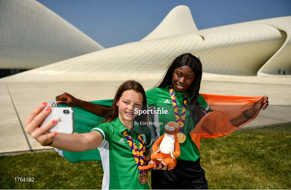 27 July 2019; Molly Mayne, left, and Rhasidat Adeleke of Ireland pose for a portrait with their 100m  and 200m breaststroke Bronze medals, and 100m, 200m Gold medals in front of the Heydar Aliyev Center in Baku during Day Six of the 2019 Summer European Youth Olympic Festival in Baku, Azerbaijan. Photo by Eóin Noonan/Sportsfile