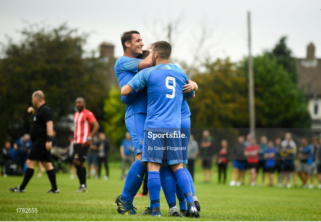 25 August 2019; Jake Donnelly of Crumlin United, hidden, is congratulated by team-mate Dean Kelly, right, and James Lee, left, after scoring his side's second goal of the game the Extra.ie FAI Cup Second Round match between Crumlin United and Lucan United at CBS Captain's Road in Crumlin, Dublin. Photo by David Fitzgerald/Sportsfile
