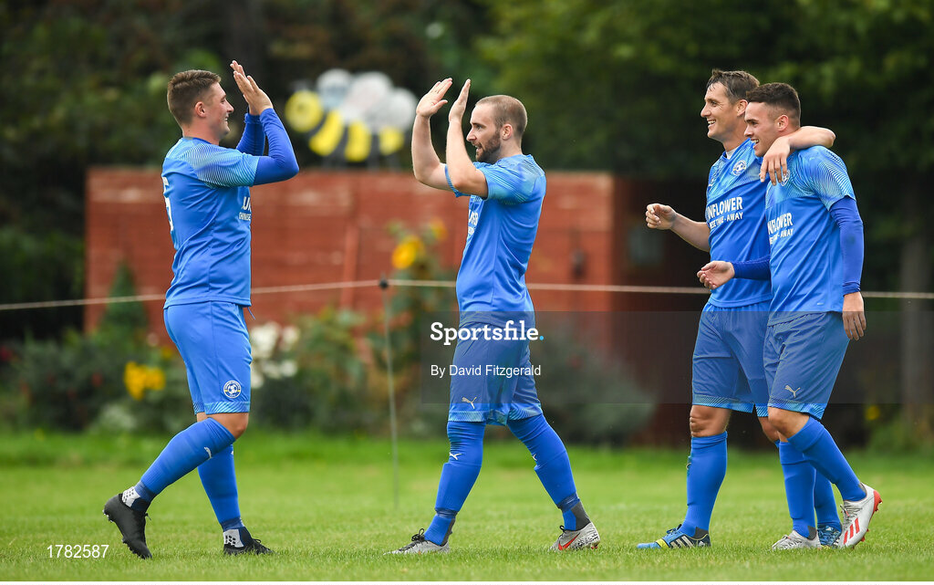 25 August 2019; Alan McGreal of Crumlin United, centre, celebrates after scoring his side's third goal of the game with team-mate Jake Donnelly, left, during the Extra.ie FAI Cup Second Round match between Crumlin United and Lucan United at CBS Captain's Road in Crumlin, Dublin. Photo by David Fitzgerald/Sportsfile