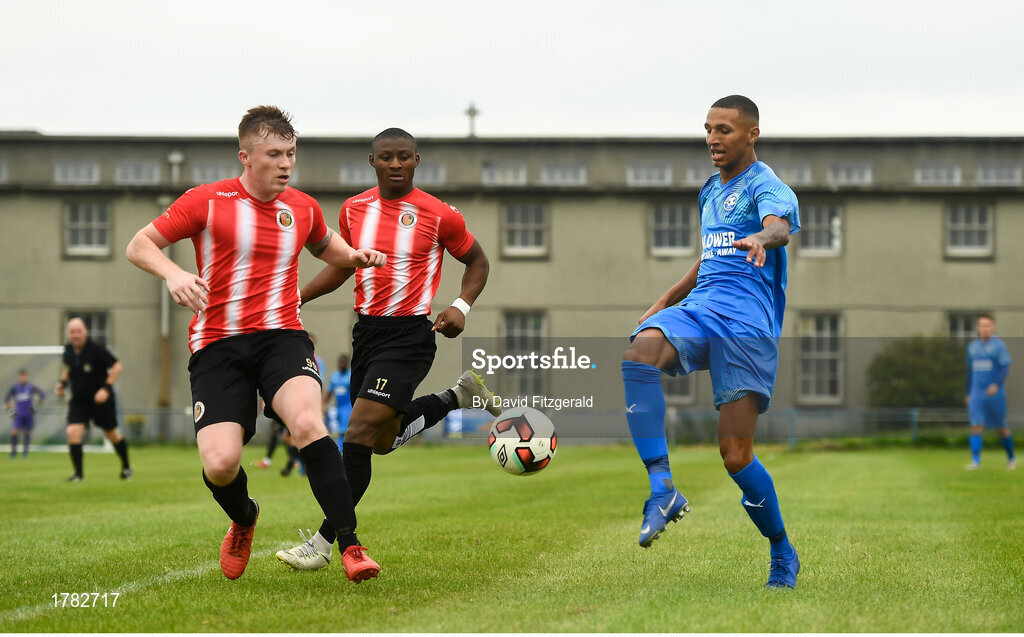 25 August 2019; Sam Burgess of Crumlin United in action against Sean Cronin of Lucan United during the Extra.ie FAI Cup Second Round match between Crumlin United and Lucan United at CBS Captain's Road in Crumlin, Dublin. Photo by David Fitzgerald/Sportsfile