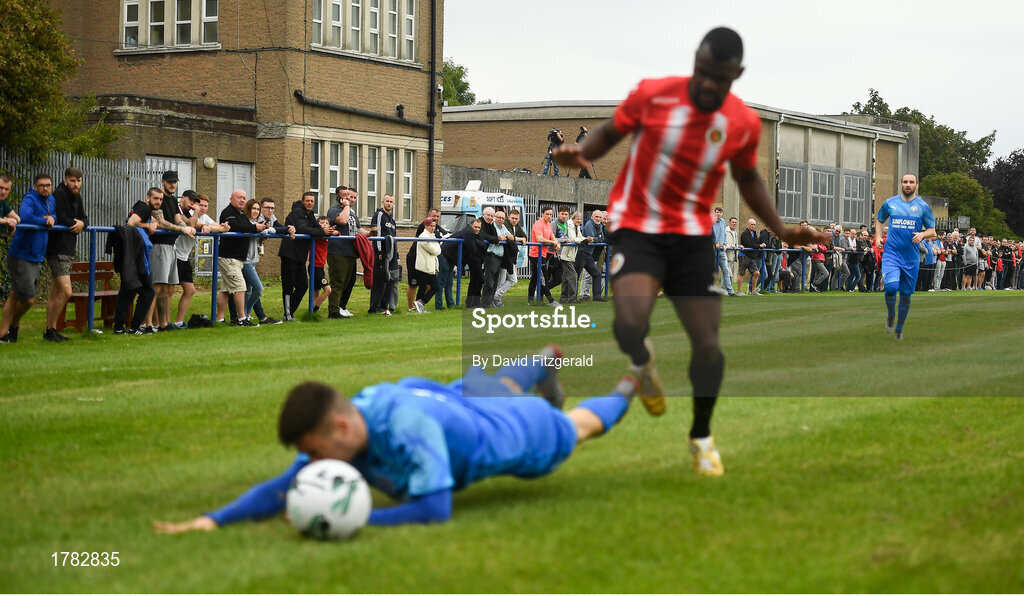 25 August 2019; Supporters look on as Liam Brady of Crumlin United is tackled by Tamena Dinamunenga of Lucan United during the Extra.ie FAI Cup Second Round match between Crumlin United and Lucan United at CBS Captain's Road in Crumlin, Dublin. Photo by David Fitzgerald/Sportsfile