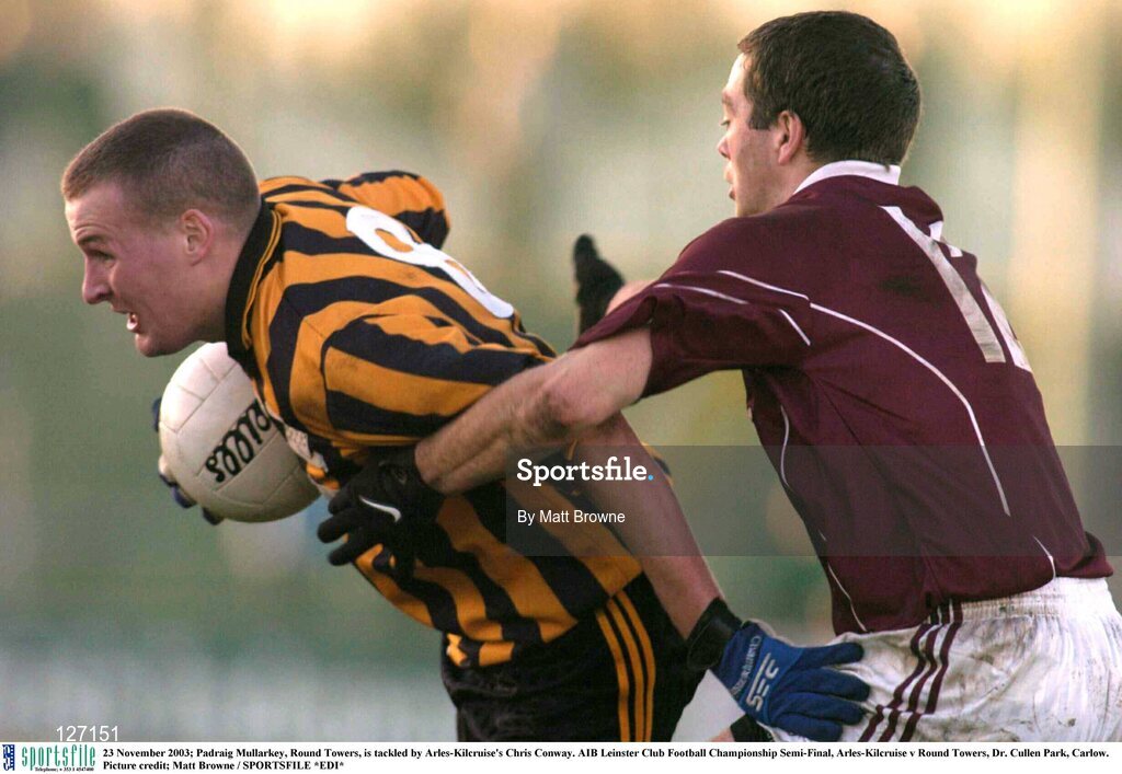 23 November 2003; Padraig Mullarkey, Round Towers, is tackled by Arles-Kilcruise's Chris Conway. AIB Leinster Club Football Championship Semi-Final, Arles-Kilcruise v Round Towers, Dr. Cullen Park, Carlow. Picture credit; Matt Browne / SPORTSFILE *EDI*