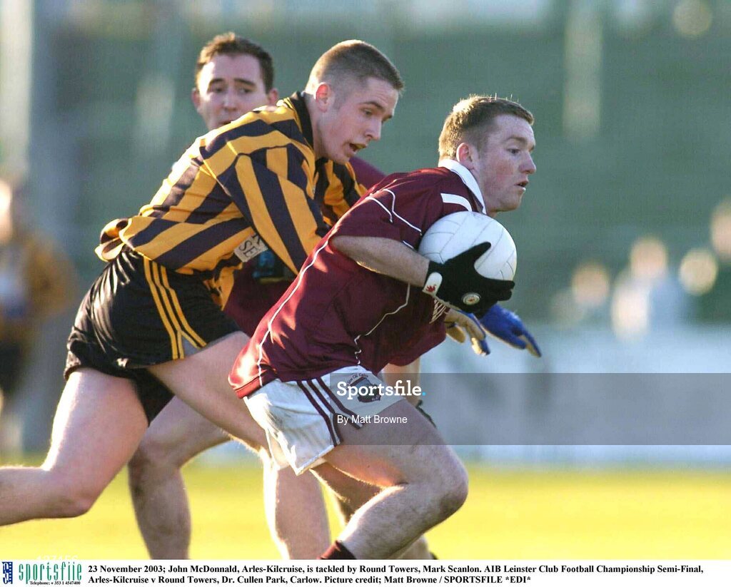 23 November 2003; John McDonnald, Arles-Kilcruise, is tackled by Round Towers, Mark Scanlon. AIB Leinster Club Football Championship Semi-Final, Arles-Kilcruise v Round Towers, Dr. Cullen Park, Carlow. Picture credit; Matt Browne / SPORTSFILE *EDI*