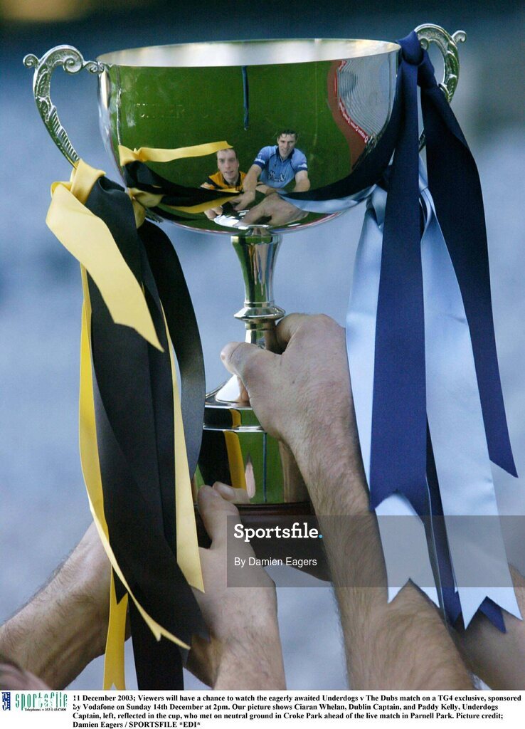 11 December 2003; Viewers will have a chance to watch the eagerly awaited Underdogs v The Dubs match on a TG4 exclusive, sponsored by Vodafone on Sunday 14th December at 2pm. Our picture shows Ciaran Whelan, Dublin Captain, and Paddy Kelly, Underdogs Captain, left, reflected in the cup, who met on neutral ground in Croke Park ahead of the live match in Parnell Park. Picture credit; Damien Eagers / SPORTSFILE *EDI*