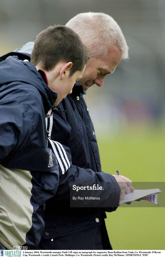 4 January 2004; Westmeath manager Paidi î SŽ signs an autograph for supporter Dean Reddan from Tanh, Co. Westmeath. O'Byrne Cup, Westmeath v Louth, Cusack Park, Mullingar, Co. Westmeath. Picture credit; Ray McManus / SPORTSFILE *EDI*