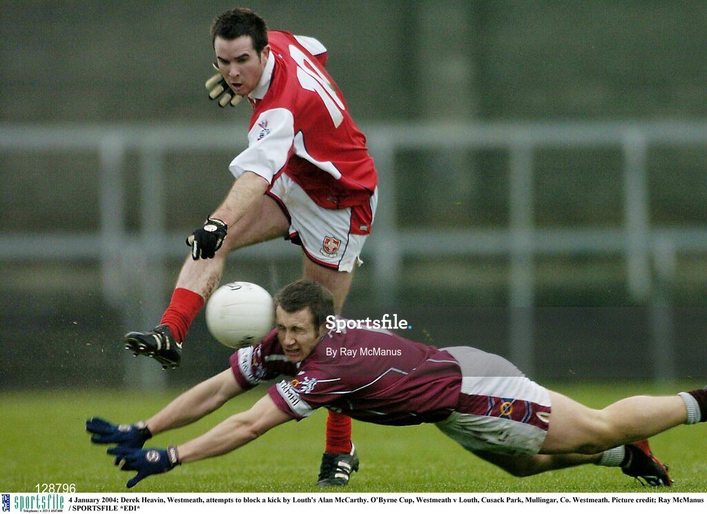 4 January 2004; Derek Heavin, Westmeath, attempts to block a kick by Louth's Alan McCarthy. O'Byrne Cup, Westmeath v Louth, Cusack Park, Mullingar, Co. Westmeath. Picture credit; Ray McManus / SPORTSFILE *EDI*