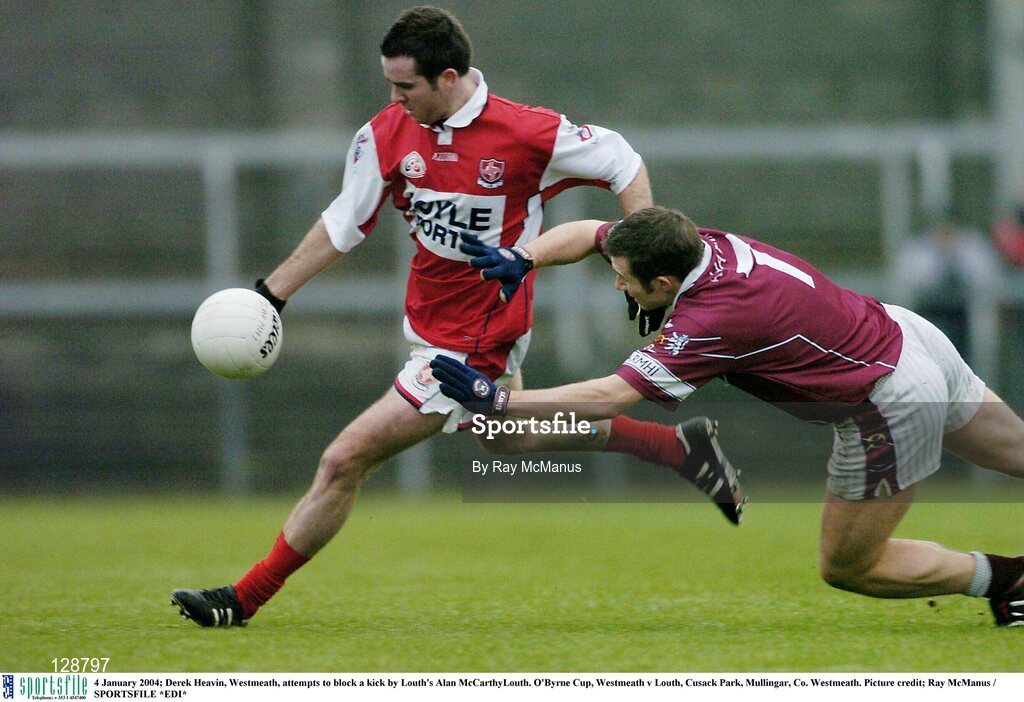 4 January 2004; Derek Heavin, Westmeath, attempts to block a kick by Louth's Alan McCarthyLouth. O'Byrne Cup, Westmeath v Louth, Cusack Park, Mullingar, Co. Westmeath. Picture credit; Ray McManus / SPORTSFILE *EDI*