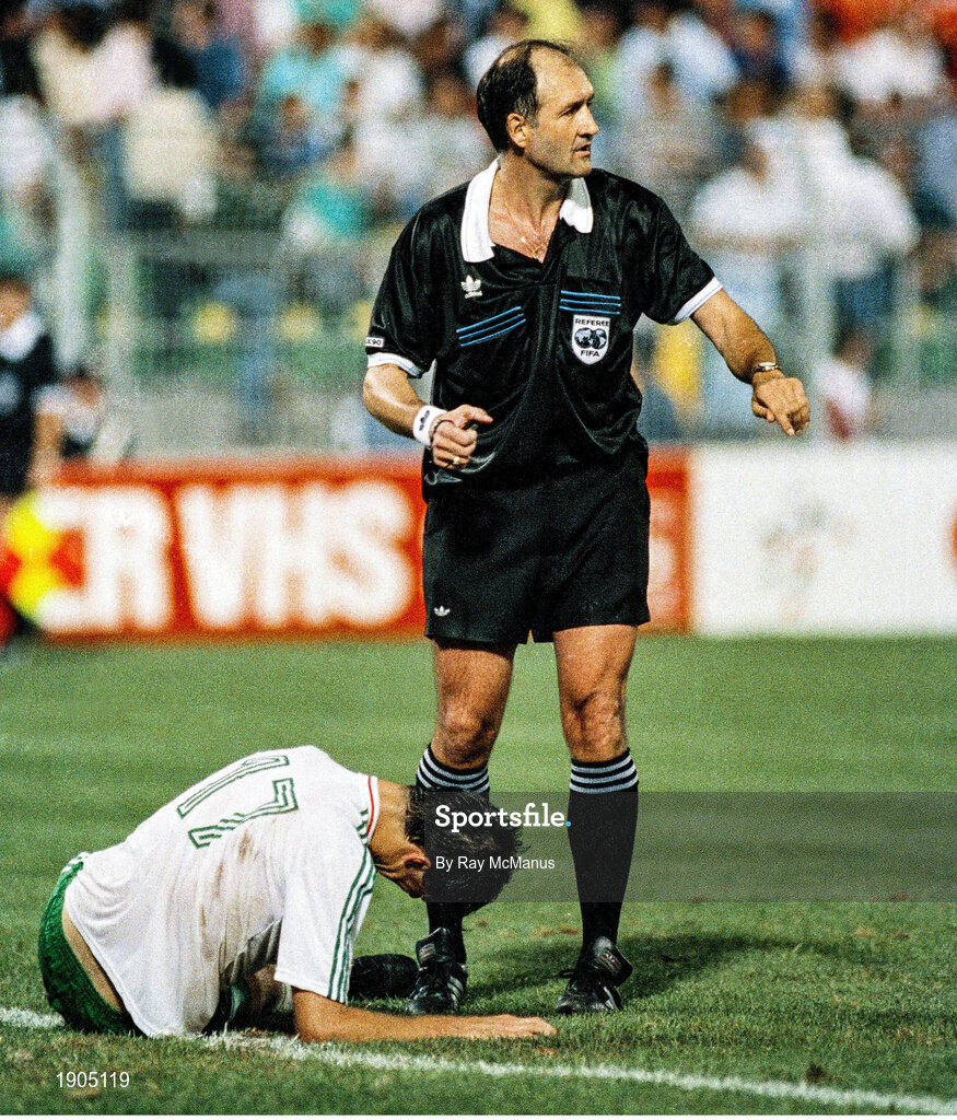21 June 1990; Referee Michel Vautrot calls for medical assistance for Niall Quinn Republic of Ireland during the FIFA World Cup 1990 Group F match between Republic of Ireland and Netherlands at Stadio La Favorita in Palermo, Italy. Photo by Ray McManus/Sportsfile