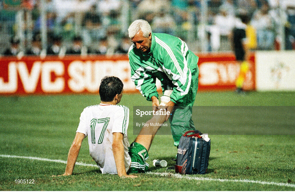 21 June 1990; Niall Quinn of Republic of Ireland is attended to by team physio Mick Byrne during the FIFA World Cup 1990 Group F match between Republic of Ireland and Netherlands at Stadio La Favorita in Palermo, Italy. Photo by Ray McManus/Sportsfile