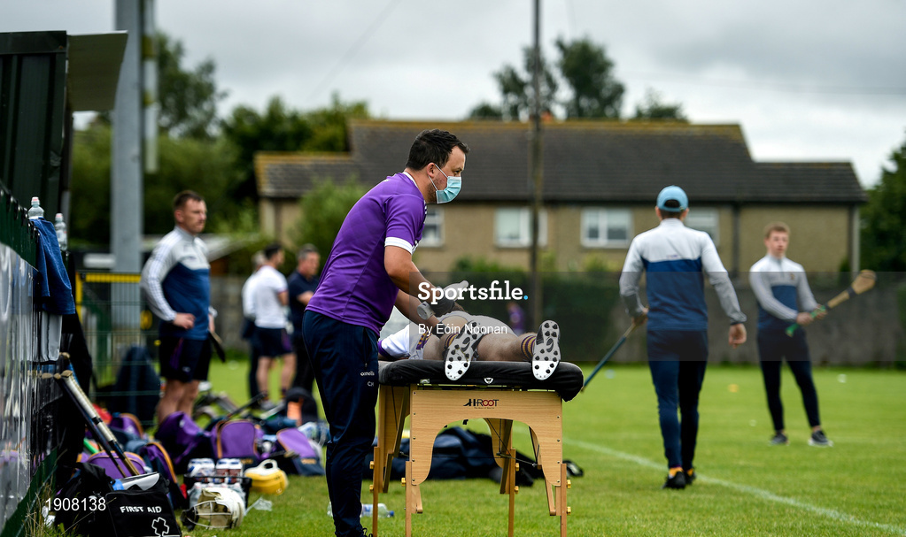 18 July 2020; Faythe Harriers physio Craig Hore attending to a players ahead of the Wexford County Senior Hurling Championship Group B Round 1 match between Ferns St Aidan's and Faythe Harriers at Bellefield in Enniscorthy, Wexford. Competitive GAA matches have been approved to return following the guidelines of Phase 3 of the Irish Government’s Roadmap for Reopening of Society and Business and protocols set down by the GAA governing authorities. With games having been suspended since March, competitive games can take place with updated protocols including a limit of 200 individuals at any one outdoor event, including players, officials and a limited number of spectators, with social distancing, hand sanitisation and face masks being worn by those in attendance among other measures in an effort to contain the spread of the Coronavirus (COVID-19) pandemic. Photo by Eóin Noonan/Sportsfile