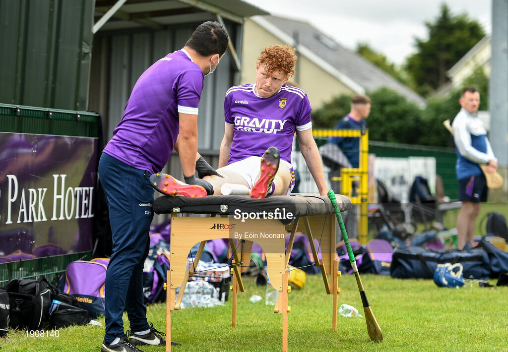 18 July 2020; Dean Welsh of Faythe Harriers receives physio from Craig Hore in the dug-out ahead of the Wexford County Senior Hurling Championship Group B Round 1 match between Ferns St Aidan's and Faythe Harriers at Bellefield in Enniscorthy, Wexford. Competitive GAA matches have been approved to return following the guidelines of Phase 3 of the Irish Government’s Roadmap for Reopening of Society and Business and protocols set down by the GAA governing authorities. With games having been suspended since March, competitive games can take place with updated protocols including a limit of 200 individuals at any one outdoor event, including players, officials and a limited number of spectators, with social distancing, hand sanitisation and face masks being worn by those in attendance among other measures in an effort to contain the spread of the Coronavirus (COVID-19) pandemic. Photo by Eóin Noonan/Sportsfile