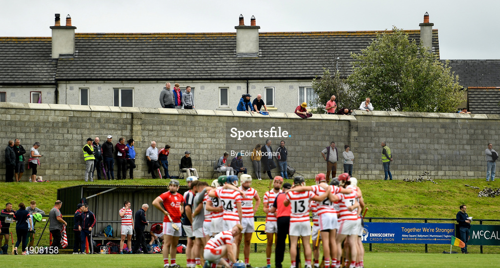 18 July 2020; Supporters take their places on a wall of a neighbouring estate as the teams huddle ahead of the Wexford County Senior Hurling Championship Group B Round 1 match between Ferns St Aidan's and Faythe Harriers at Bellefield in Enniscorthy, Wexford. Competitive GAA matches have been approved to return following the guidelines of Phase 3 of the Irish Government’s Roadmap for Reopening of Society and Business and protocols set down by the GAA governing authorities. With games having been suspended since March, competitive games can take place with updated protocols including a limit of 200 individuals at any one outdoor event, including players, officials and a limited number of spectators, with social distancing, hand sanitisation and face masks being worn by those in attendance among other measures in an effort to contain the spread of the Coronavirus (COVID-19) pandemic. Photo by Eóin Noonan/Sportsfile