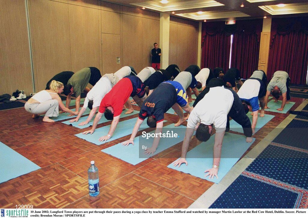 10 June 2002; Longford Town players are put through their paces during a yoga class by teacher Emma Stafford and watched by manager Martin Lawlor at the Red Cow Hotel, Dublin. Soccer. Picture credit; Brendan Moran / SPORTSFILE