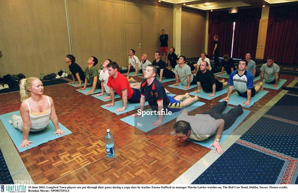 10 June 2002; Longford Town players are put through their paces during a yoga class by teacher Emma Stafford as manager Martin Lawlor watches on, The Red Cow Hotel, Dublin. Soccer. Picture credit; Brendan Moran / SPORTSFILE
